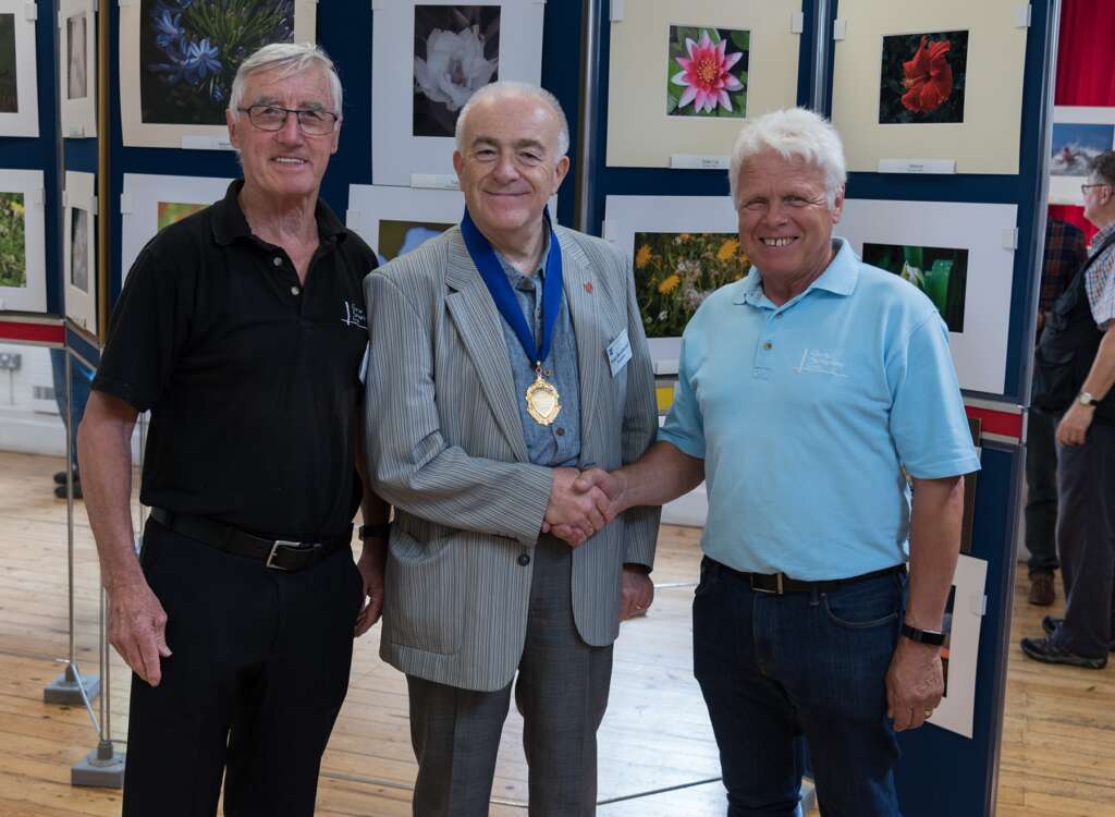 Club officers shake hands with the Southern Counties Photographic Federation President.